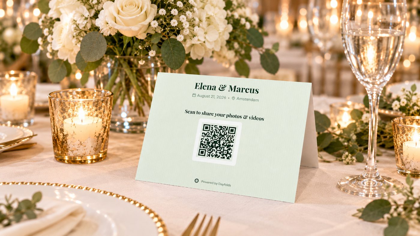 A Dayfolds wedding table card with a QR code to share photos and videos, standing on a reception table